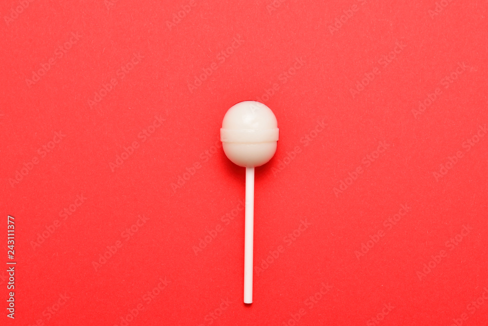 Lollipop on a red background. Space for text or design. Lollipop on a red background. Space for text or design.