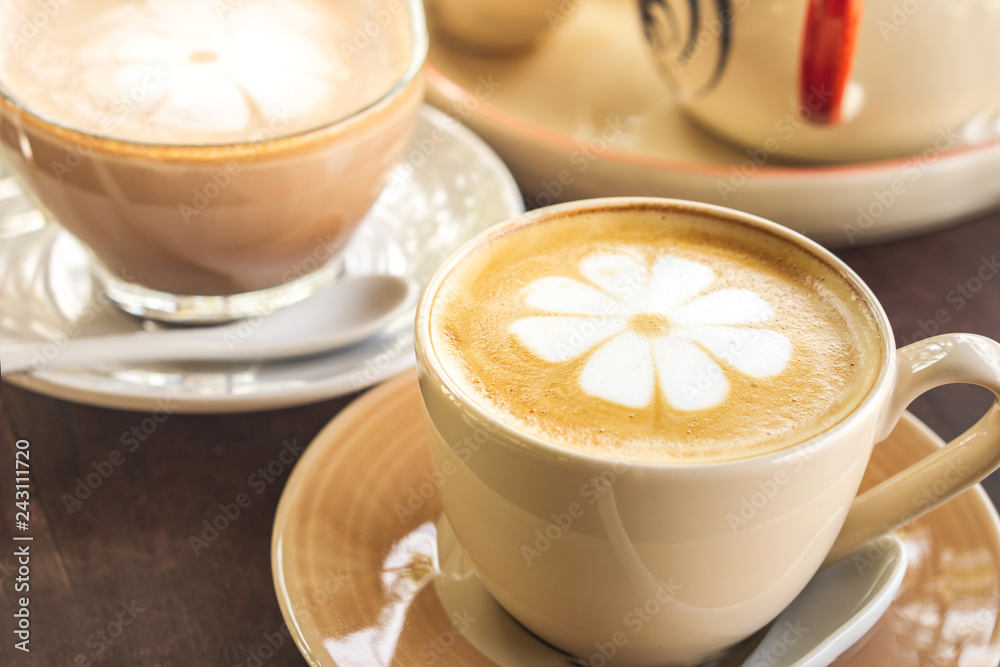 closeup cup of hot coffee latte art on wooden table in coffee shop closeup cup of hot coffee latte art on wooden table in coffee shop