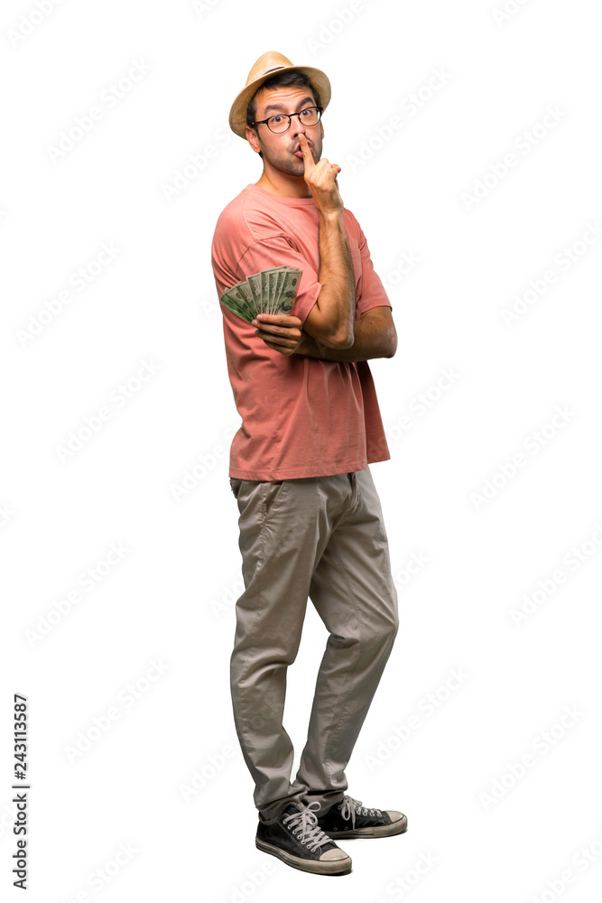 Man holding many bills showing a sign of closing mouth and silence gesture on isolated white background Man holding many bills showing a sign of closing mouth and silence gesture on isolated white background