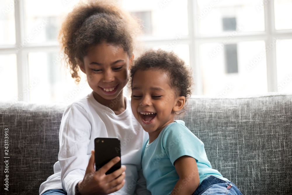 Boys are enjoying playing online games in their mobile phones