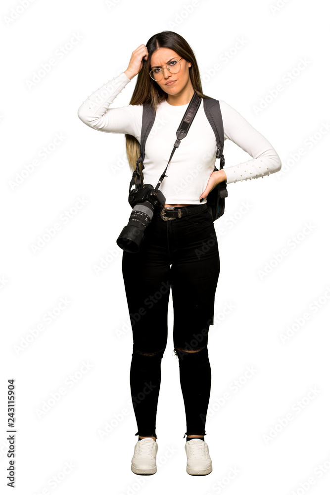 Full body of Young photographer woman having doubts while scratching head Full body of Young photographer woman having doubts while scratching head
