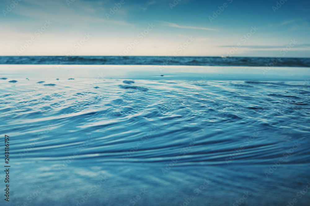 Fototapeta premium Details of ocean water ripples with blue color tones. German Baltic Sea Darßer Ort, Weststrand coastline at Fischland-Darss-Zingst 