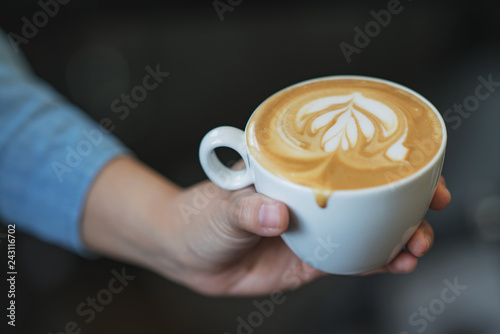 Latte art coffee in hands