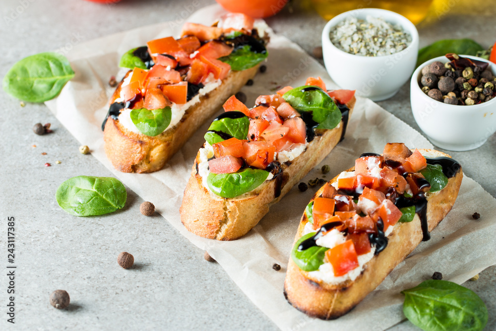 Tomato and cheese fresh made bruschetta. Italian tapas, antipasti with vegetables, herbs and oil on grilled ciabatta and baguette bread. Sandwich. Tomato and cheese fresh made bruschetta. Italian tapas, antipasti with vegetables, herbs and oil on grilled ciabatta and baguette bread. Sandwich.