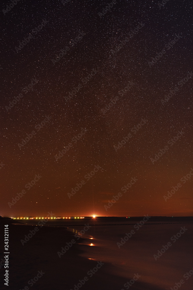 Lighthouse Darßer Ort at night with the stars and milky way on the beach. German Baltic Sea Darßer Ort, Weststrand coastline at Fischland-Darss-Zingst Lighthouse Darßer Ort at night with the stars and milky way on the beach. German Baltic Sea Darßer Ort, Weststrand coastline at Fischland-Darss-Zingst
