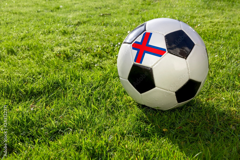 Fototapeta premium Football on a grass pitch with Faroe Islands