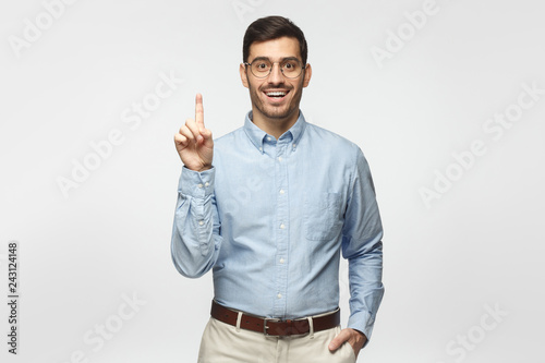 I have a great idea! Handsome businessman, pointing up with index finger. Eureka, solution sign concept