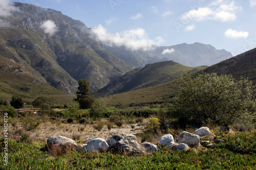 Lush mountain ranges behind a rocky river bed with sunny weather in Greyton, Cape Town, South Africa