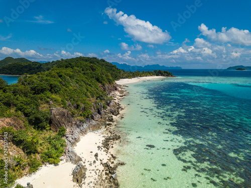 Aerial view of tropical beach on the island Malcapuya. Beautiful tropical island with sand beach, palm trees. Tropical landscape with shore and boat. Palawan, Philippines © umike_foto