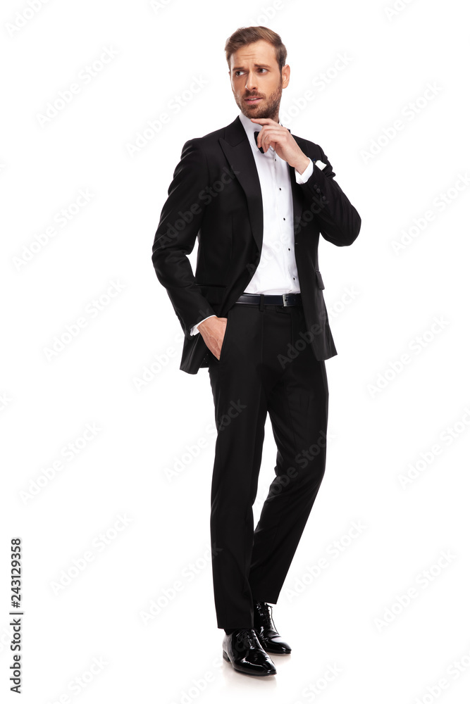 relaxed businessman in black suit standing and looking to side relaxed businessman in black suit standing and looking to side