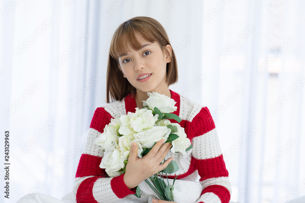 Beautiful Asian woman smile and holding flower or bouquet feeling so happiness and cheerful Beautiful Asian woman smile and holding flower or bouquet feeling so happiness and cheerful