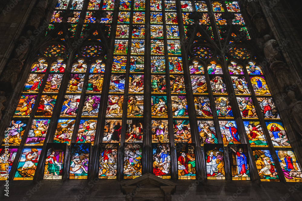 MILAN, ITALY - AUGUST 18 2018: Giant colorful window of Milano Duomo Cathedral with apostolic depictions