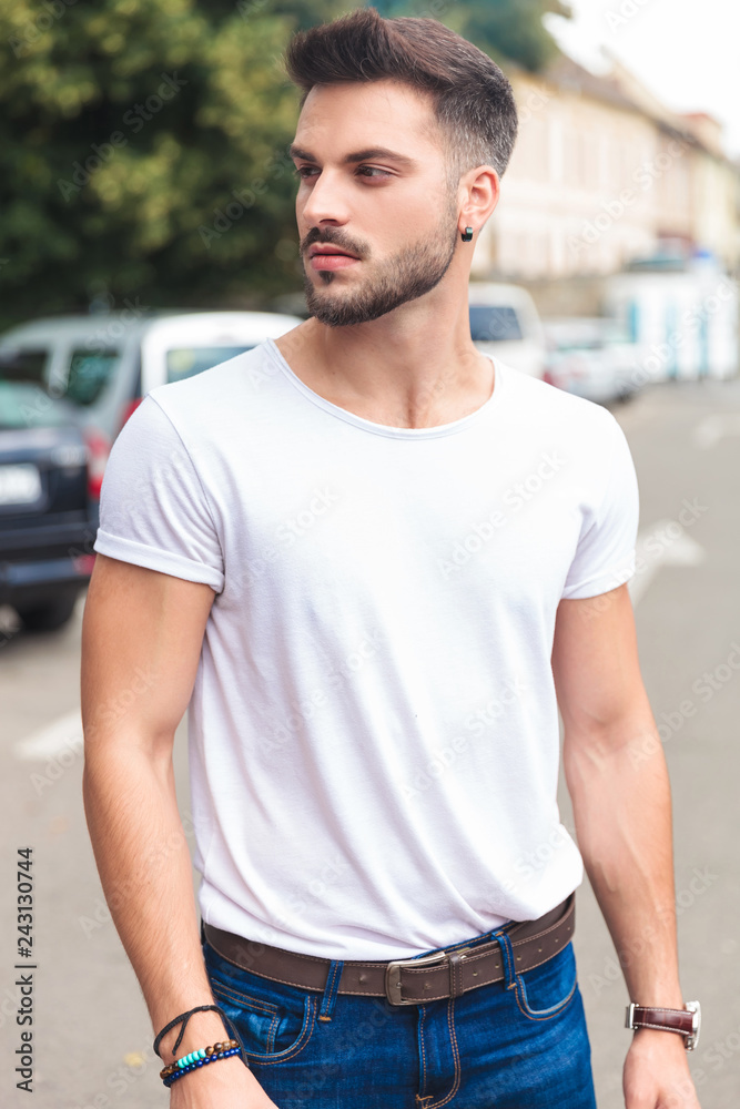 portrait of casual man looking to side while on street
