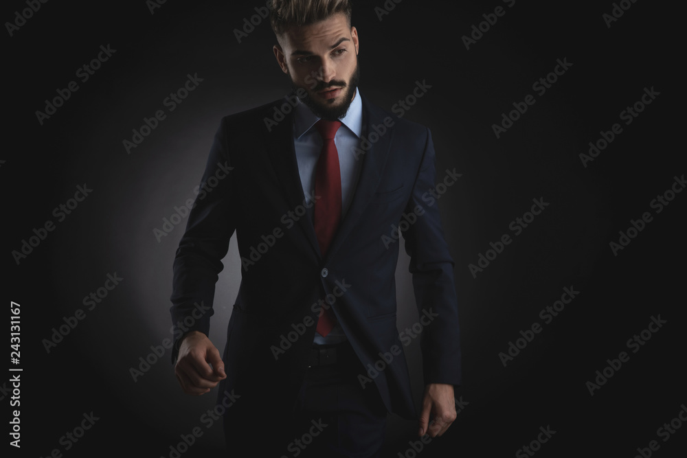 sexy businessman walks forward and looks down to side sexy businessman walks forward and looks down to side