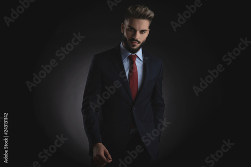 portrait of relaxed smart casual man holding pockets while standing