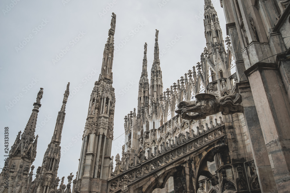 Roof terraces of gothic Milan Cathedral, or Duomo di Milano, at sunset. The beautiful gothic cathedral is the main tourist attraction of Milan, Lombardy, Italy