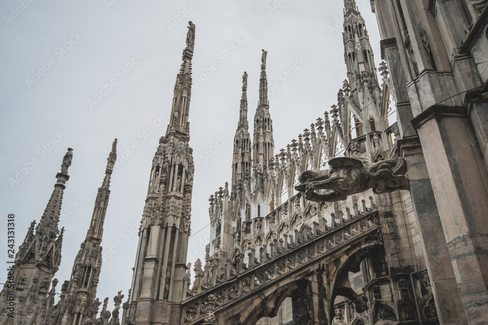 Roof terraces of gothic Milan Cathedral, or Duomo di Milano, at sunset. The beautiful gothic cathedral is the main tourist attraction of Milan, Lombardy, Italy Roof terraces of gothic Milan Cathedral, or Duomo di Milano, at sunset. The beautiful gothic cathedral is the main tourist attraction of Milan, Lombardy, Italy
