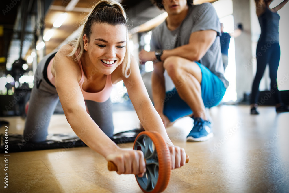 Fit sportswoman exercising and training at fitness club Fit sportswoman exercising and training at fitness club