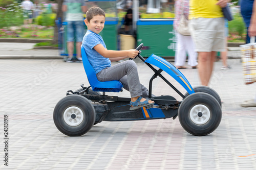 Boy on pedal car