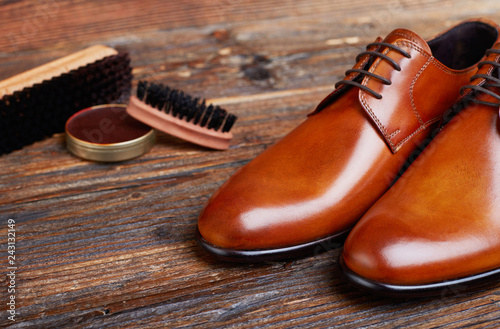 Men shoes and care products on wood