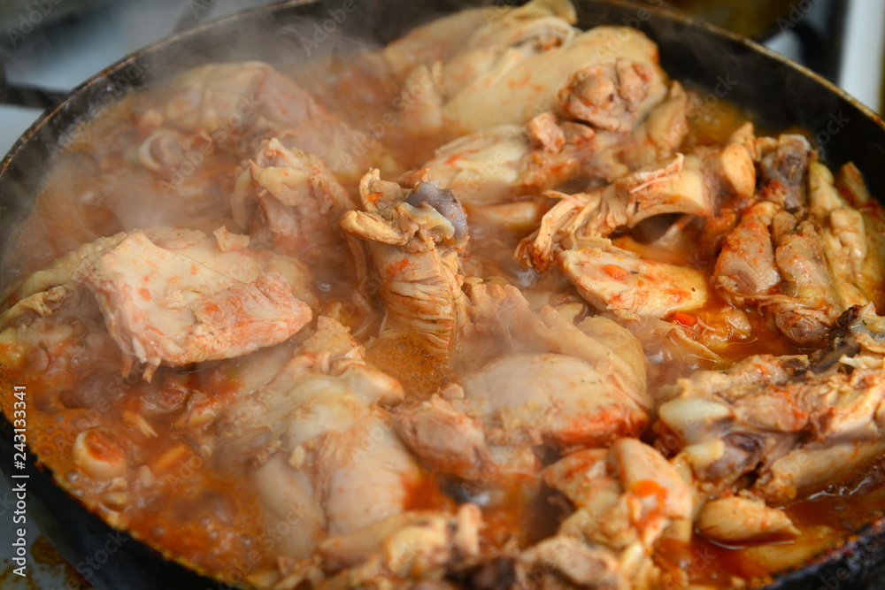 Fried chicken with spices in a pan Fried chicken with spices in a pan