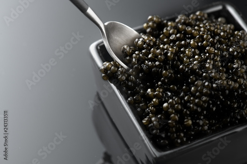 Black Caviar in a spoon. Natural sturgeon black caviar closeup. Delicatessen