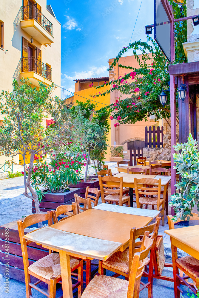 Sunny Open Air Cafe in Chania City on Crete. With Flowers and Olive Trees All Round in Crete, Greece.