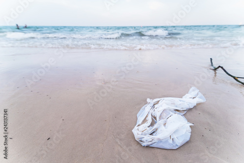 White plastic bag rubbish dump on sand sea beach from deep sea after finish strong wind.Thailand.