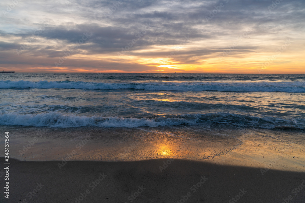 View of sea and waves at sunset