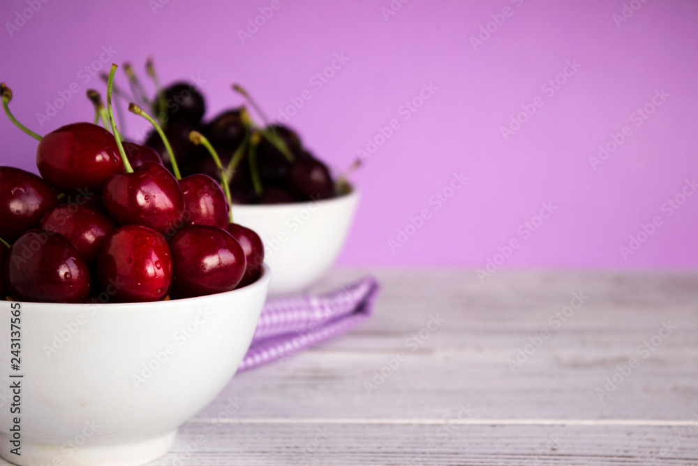Ripe cherry berries in two white plates, fruit, background