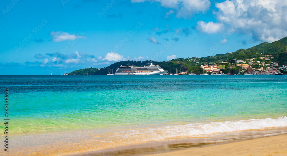 Tropical beach with in the background a luxury cruise ship in the harbor. Tropical beach with in the background a luxury cruise ship in the harbor.