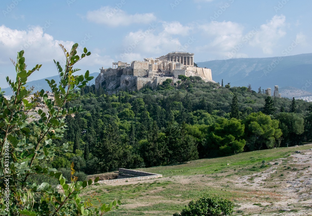 .Acropolis photographed from the Pnyka hill on a beautiful sunny day..Blue sky and nature tied harmonically with the monument.