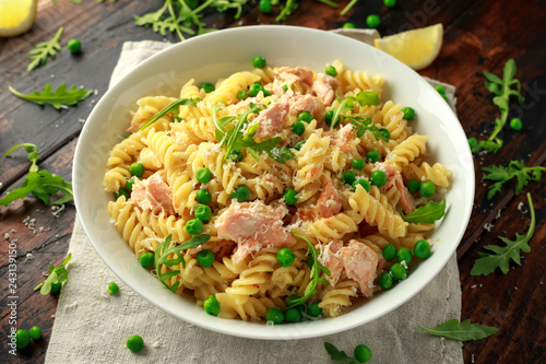 Homemade Pasta fusilli with salmon, green peas, parmesan cheese and lemon. healthy food