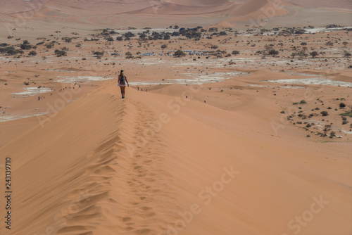 girl walking the dunes in namib desert deadvlei namib desert namibia