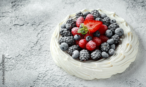 Berry Pavlova cake with fresh blueberries, strawberries and raspberries