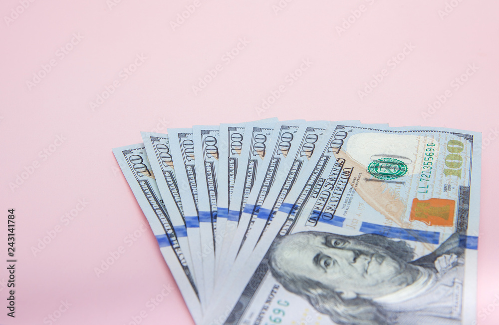 One hundred dollars banknotes on pink background. Flat lay, top view, copy space One hundred dollars banknotes on pink background. Flat lay, top view, copy space