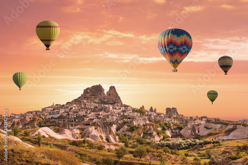 Colorful hot air balloons flying over the valley at Cappadocia, Uchisar, Turkey. Volcanic mountains in Goreme national park