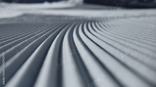 Prepared ski slope with a snow lines