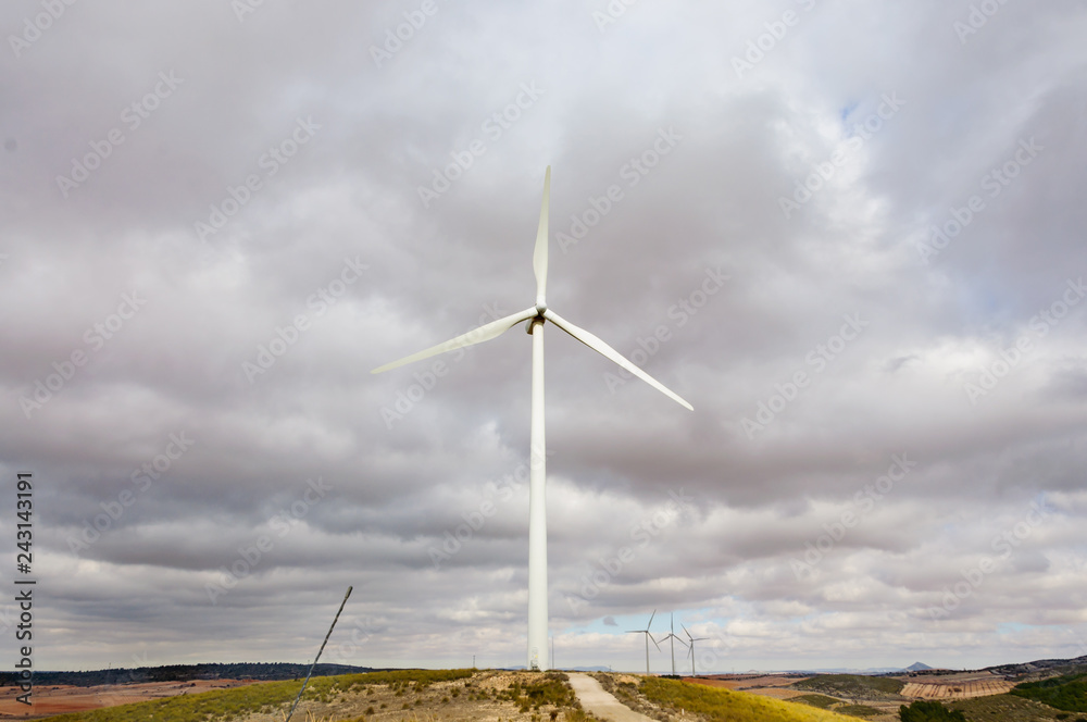 wind turbines in the field against blue cloudy sky, electric generators in countryside wind turbines in the field against blue cloudy sky, electric generators in countryside