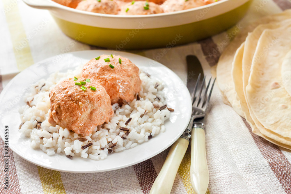 Chicken meatballs in creamy tomato sauce with rice Chicken meatballs in creamy tomato sauce with rice