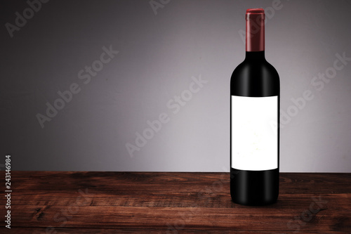 a bottle of red wine on boards