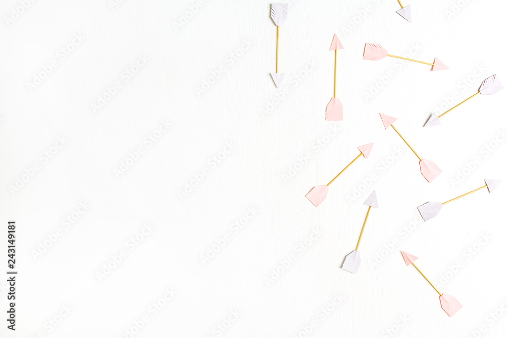 Paper Cupid arrow symbols on pink background. Flat lay, top view Valentines Day background love concept. Paper Cupid arrow symbols on pink background. Flat lay, top view Valentines Day background love concept.