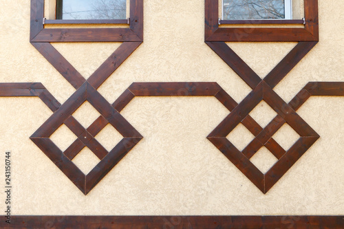 Modern wooden design of the facade of the building. Pseudo half-timbered houses.