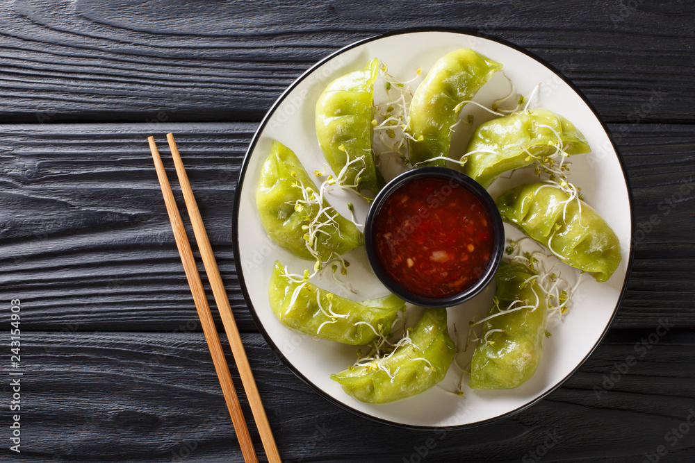 Japanese gyoza with matcha served with sauce and microgreen close-up. horizontal top view Japanese gyoza with matcha served with sauce and microgreen close-up. horizontal top view