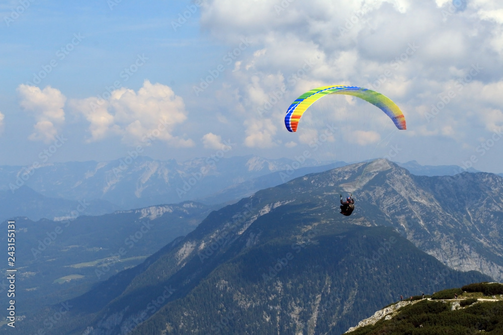 Paraglider over the tops of the mountains in summer sunny day. Paraglider over the tops of the mountains in summer sunny day.