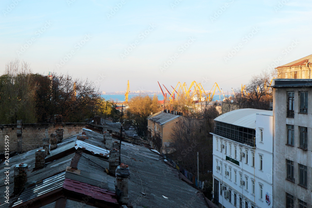 View of the seaport of the city of Odessa, against the background of old, decaying buildings.
