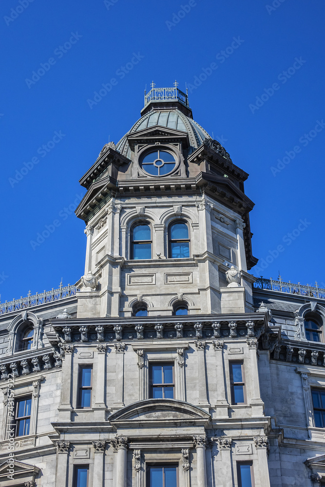 Victorian building surmounted by a copper dome (1878). This Magnificent building first housed offices of the Commissioners (edifice des commissaires) of the Port of Montreal. Montreal, Quebec, Canada.