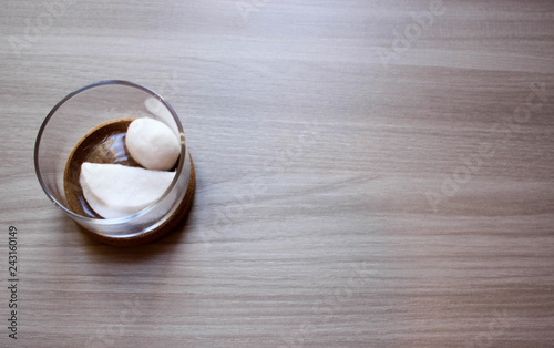 Containers of cotton health care supplies over wooden background