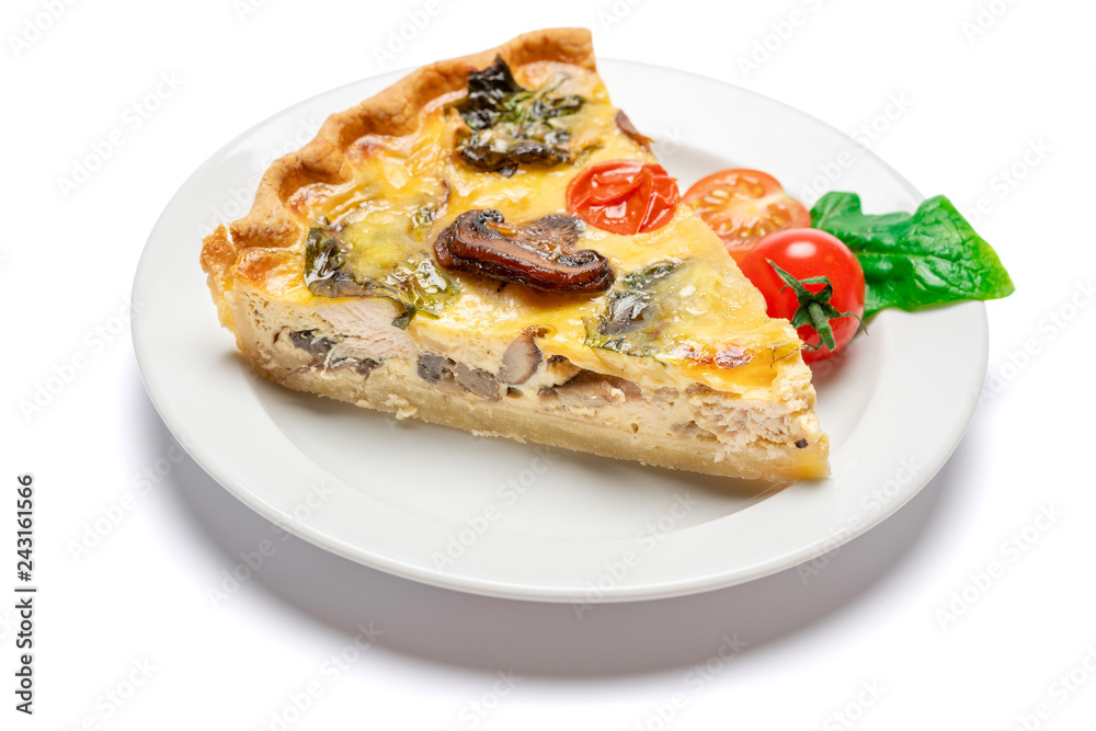 Slice of traditonal homemade spinach chicken quiche tart or pie on plate Slice of traditonal homemade spinach chicken quiche tart or pie on plate