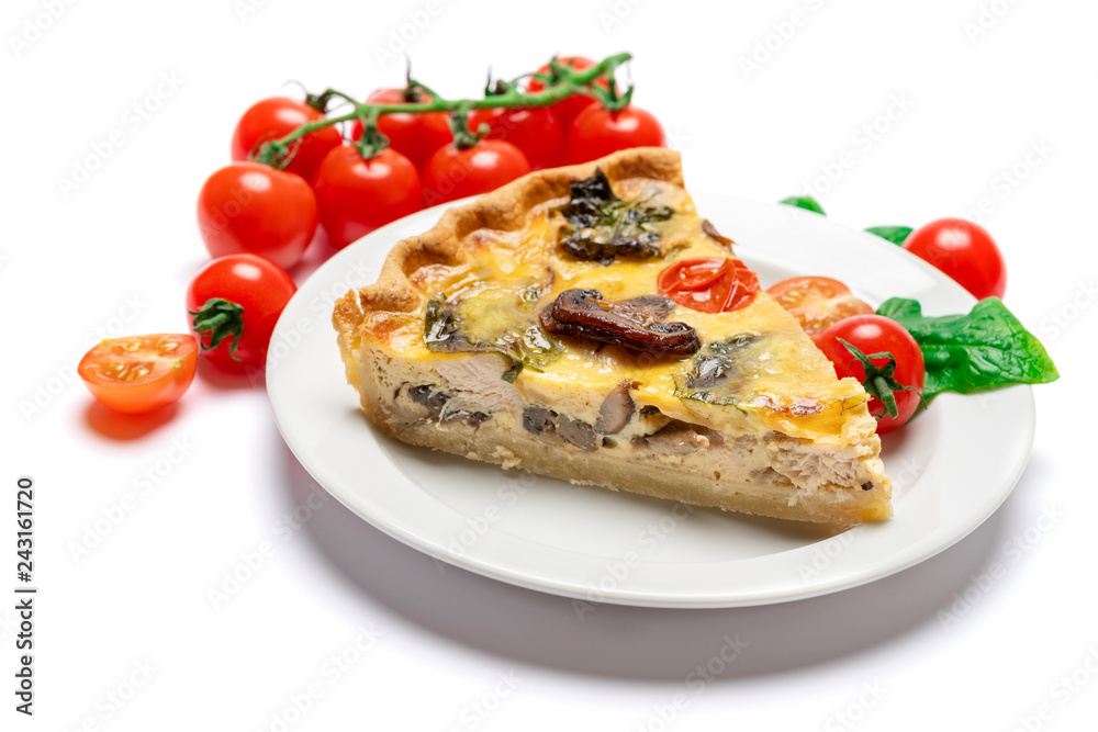 Slice of traditonal homemade spinach chicken quiche tart or pie on plate Slice of traditonal homemade spinach chicken quiche tart or pie on plate